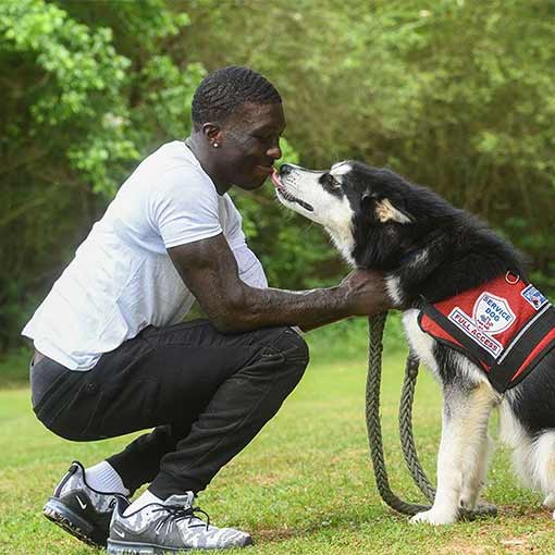Photo of Jalen Richardson with a service dog