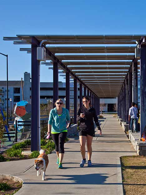 Two women walking a dog through an Atlanta park